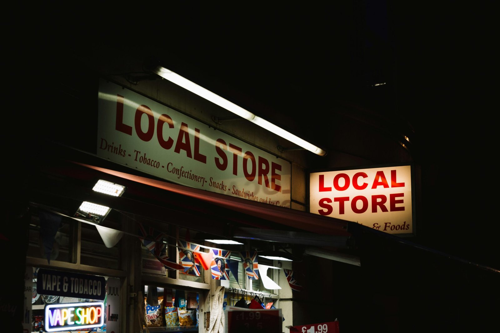 An urban local store glowing with neon signs during nighttime, capturing the essence of city nightlife.